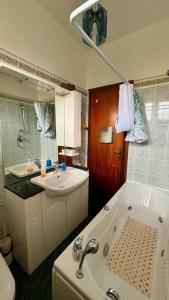 a bathroom with a bath tub and a sink at Casa Smeraldo in Ameglia +22 photos