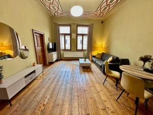 a living room with a couch and a table at Historický stylový apartmán v srdci Hradec Králové in Hradec Králové