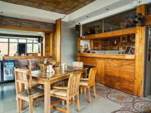 a dining room with a wooden table and chairs at Villa Alizée Boutique Hotel - Idéal Couples & Pros - Rooftop in Port Louis