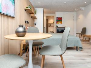 a dining room with a table and chairs at Søndervig Holiday Center in Ringkøbing