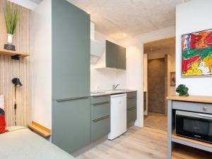 a kitchen with blue cabinets and a counter top at Søndervig Holiday Center in Ringkøbing
