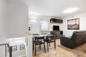 a kitchen and living room with a table and chairs at Casa Lara e Gaia - Aosta Centro in Aosta