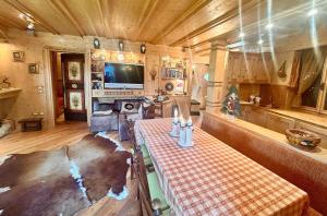 ein Wohnzimmer mit einem Tisch in einer Hütte in der Unterkunft Ca' Letizia in San Vito di Cadore