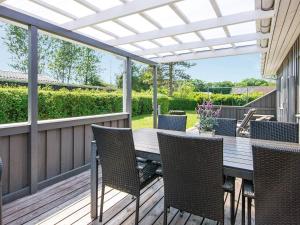 a patio with a table and chairs on a deck at 6 person holiday home in Haderslev-By Traum in Diernæs