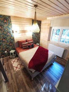 a bedroom with a bed in a room with wooden walls at Chalet - gîte avec étang in Deneuvre
