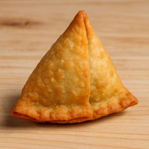 a piece of food sitting on top of a wooden table at HOTEL SUN town in Ahmedabad