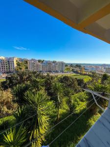 a view from the balcony of a resort with palm trees at Superhost Stay Spacious Double Rooms near Lisbon and Beaches in Corroios