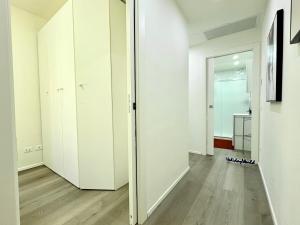 an empty hallway with white walls and wooden floors at Stella Marina by Holiday World in Varazze