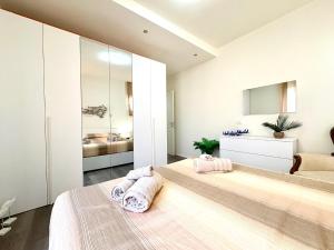 a bedroom with two beds and a mirror at Stella Marina by Holiday World in Varazze