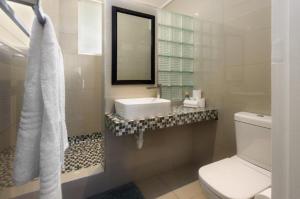 a white bathroom with a sink and a toilet at Ashley On Beach 1104 Prestige Style in Strand +20 photos