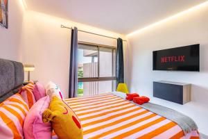 a bedroom with a bed with stuffed animals on it at Appartement luxe Prestige Opale Golf in Marrakech