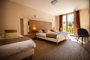 a hotel room with two beds and a window at Logis Hôtel Au Gai Soleil du Mont-Aiguille in Chichilianne +46 photos
