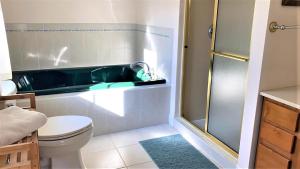 a bathroom with a toilet and a bath tub at Marlin House in Cape May +30 photos