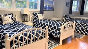 a bedroom with two beds with blue and white sheets at Marlin House in Cape May