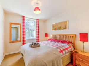 a bedroom with a bed with a teddy bear on it at South Lodge - Uk48318 in Berwick-Upon-Tweed