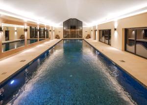 a swimming pool in a building with water in it at Knights Lodges in Newton Solney
