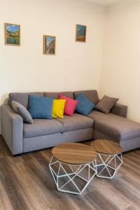a living room with a couch and two tables at Casa Perla dei Laghi - Lake View, BBQ, WiFi 1Gb & AirCond in Porlezza