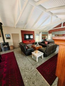 a large living room with couches and a pool table at Karibu Self-catering Accommodation in Hermanus
