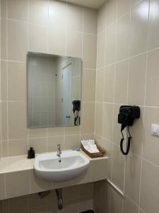 a bathroom with a sink and a mirror at Kata Kata Stay in Kata Beach