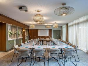a conference room with a long table and chairs at Sofitel Strasbourg Grande Ile in Strasbourg