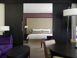 a bedroom with a bed and a table and chairs at Sofitel Strasbourg Grande Ile in Strasbourg +183 photos