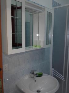 a bathroom with a sink and a mirror at Afrodite Apartment in Sabaudia