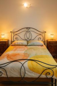 a bedroom with a large bed with two night stands at Borgo nel Vigneto in Erbusco +19 photos