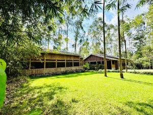 a large yard with a building and some trees at The Great Outdoors Uganda in Vumba