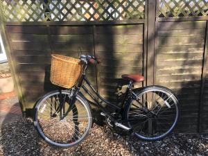 a bike with a basket parked next to a fence at 30 Park Street in Hungerford