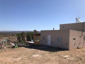 a building with a playground in front of it at casa con vista 360 a las montañas y pileta in Tanti