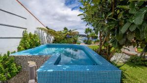 a swimming pool in the backyard of a house at INN Mountain Country House in Caniço