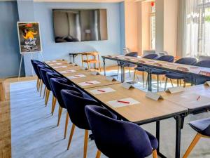 a row of tables and chairs in a room at ibis Grenoble Centre Bastille in Grenoble