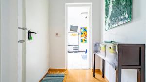 a kitchen with a refrigerator and a door with a rug at INN Mountain Country House in Caniço