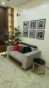 a living room with a couch and a table at MM Luxury 3 bedroom Duplex Terrance in Aja