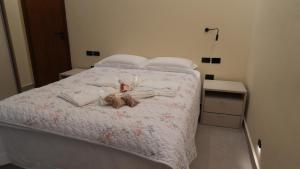 a bedroom with a bed with a teddy bear on it at Loft Jeri Premium in Jericoacoara