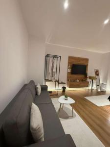 a living room with a couch and a table at You & Me Suite in Shkodër