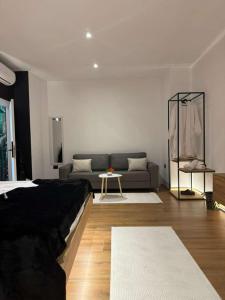 a living room with a couch and a table at You & Me Suite in Shkodër