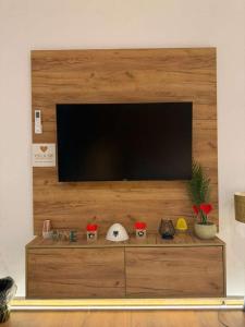 a flat screen tv on a wooden wall at You & Me Suite in Shkodër