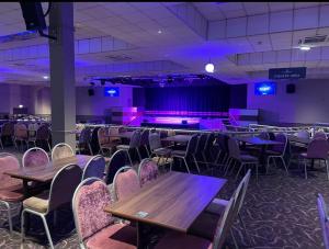 a room with tables and chairs and purple lighting at Fabulous seaside caravan getway at Cayton Bay in Scarborough +62 photos