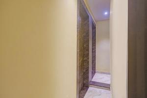 a bathroom with a mirror and a walk in shower at Via Together Stays in Rānchī +19 photos