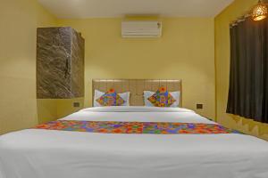 a bedroom with a large bed with white sheets at Via Together Stays in Rānchī
