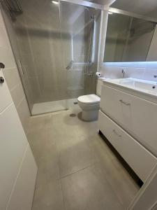 a bathroom with a shower and a toilet and a sink at LM APARTAMENTOS Aguacate Costa Tropical in Motril +13 photos
