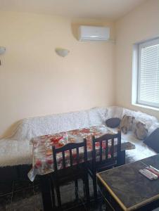 a living room with a table and a couch at стаи за настаняване in Razgrad