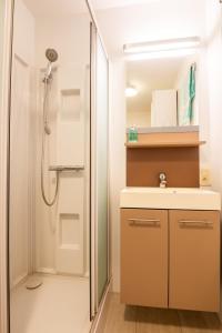 a bathroom with a shower and a sink at Cozee in Ostend