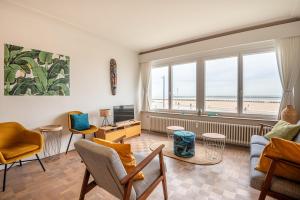 a living room with a view of the ocean at Cozee in Ostend