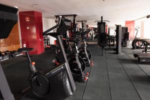 a gym with a row of bikes and weights at Gran Mareiro Hotel in Fortaleza