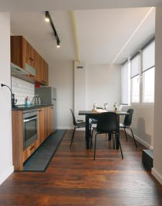 a kitchen and dining room with a table and chairs at Serdica Tower View DT Parking Wi-Fi AC in Sofia