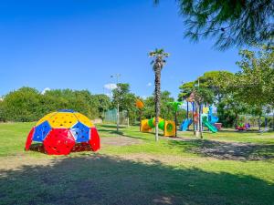 a park with a playground with a colorful play structure at Happy Camp Mobile Homes in Gitavillage California in Torre di Montalto