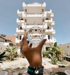 a hand holding a ball in front of a building at Serenity House Luxor in Luxor