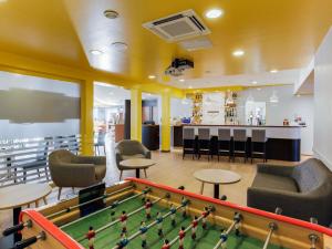 a room with a pool table and a bar at ibis Montélimar Nord in Saulce-sur-Rhône